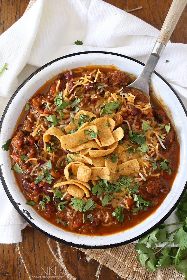 This slow cooker pumpkin chili is packed full of pumpkin puree, spicy Italian sausage and lots of beans and vegetables. This hearty soup is perfect for cold winter nights.