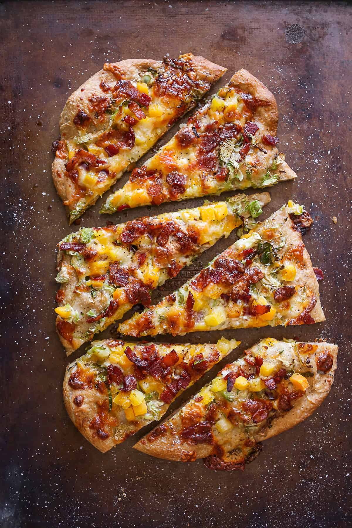 Butternut Squash Flatbread sliced on a baking sheet pan. 