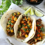 chipotle apple butter carnitas on a plate topped with toppings