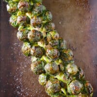 on the stalk roasted Brussels sprouts on a sheet pan