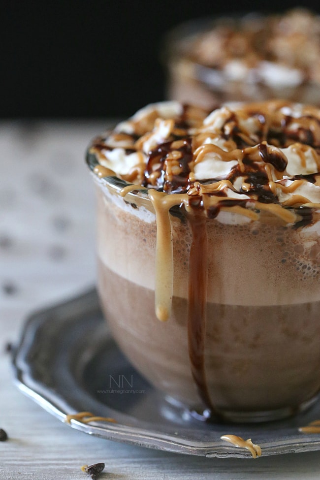 This rich and creamy peanut butter hot chocolate is perfect for keeping you warm all winter long. Plus it's super simply because it's made in your blender! That's right. I made this delicious treat right in my Vitamix! Peanut Butter Hot Chocolate topped with chocolate sauce and peanut butter.