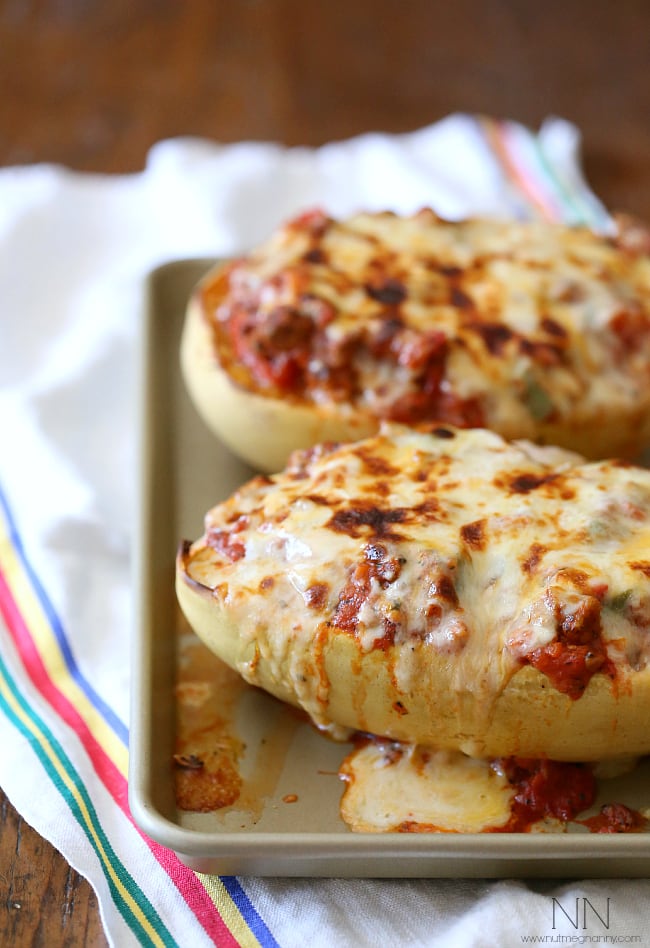 This sausage and peppers stuffed spaghetti squash is the perfect way to use up all that winter squash. Deliciously filling and and super simple to make. Sausage and Peppers Stuffed Spaghetti Squash on a sheet pan.
