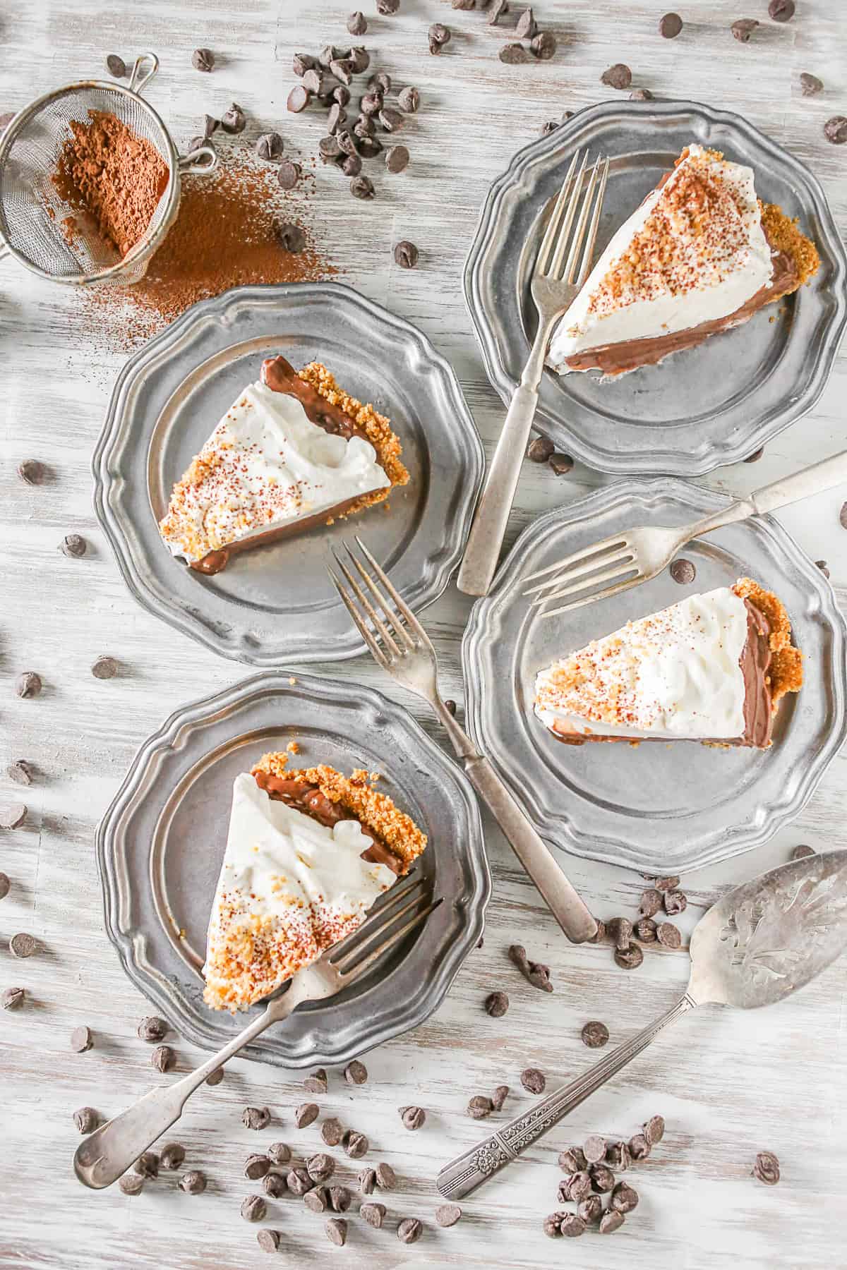 Four slices of Chocolate Orange Pudding Pie on metal plates. 