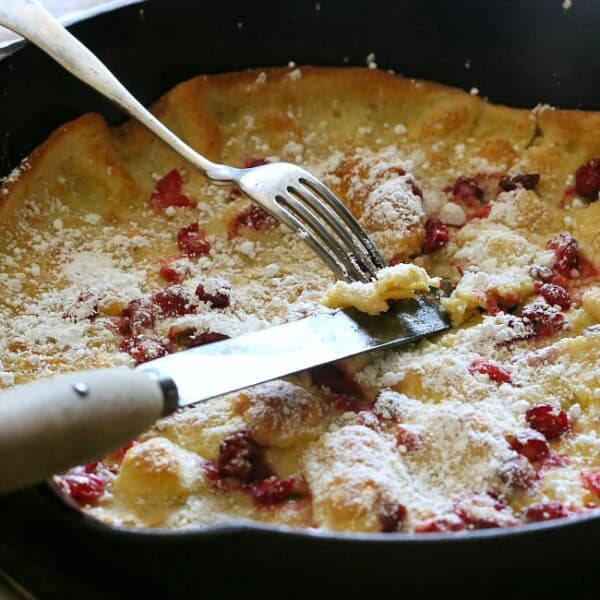 This cranberry orange Dutch baby is the highlight of your holiday season eating. Full of tart fresh cranberries and zesty orange flavor. Say hello to delicious!