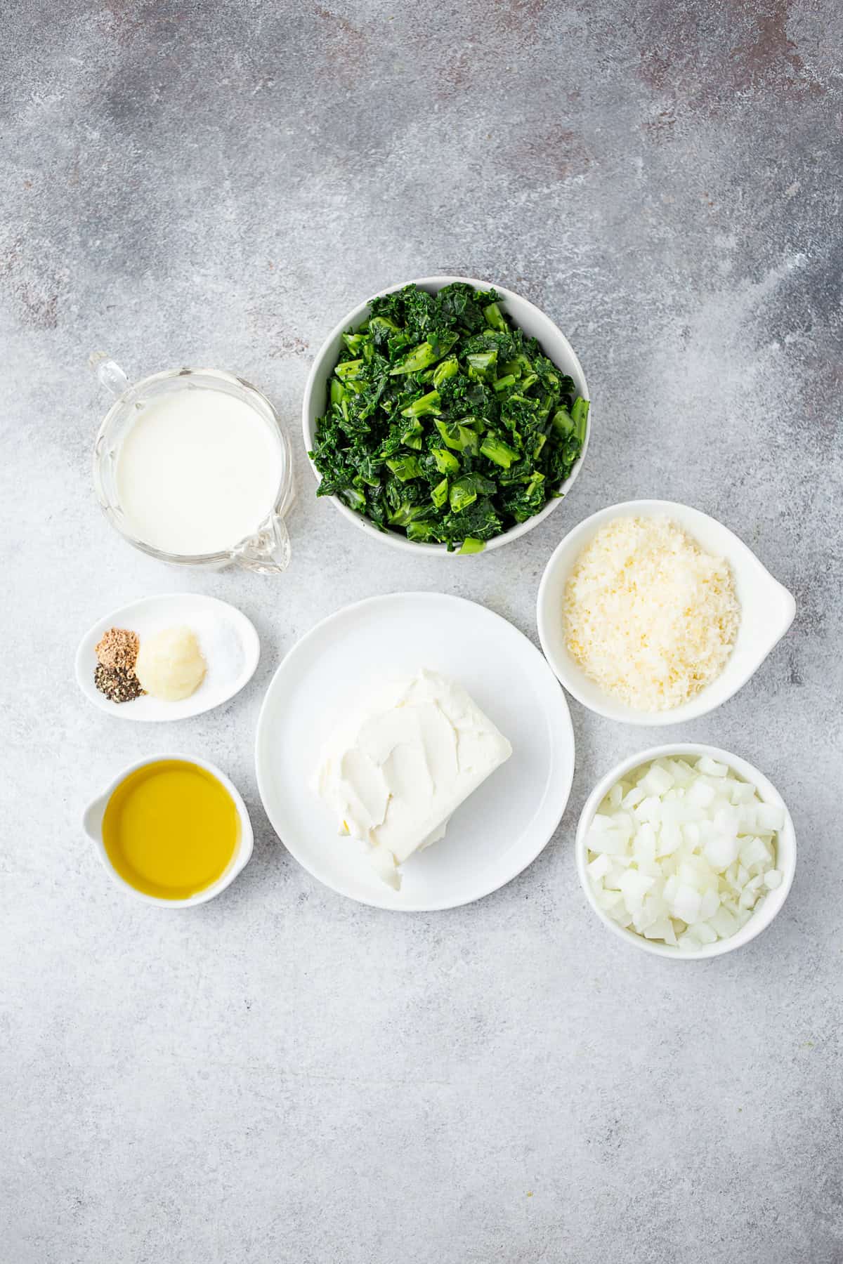 Ingredients to make Creamed Kale on a table. 