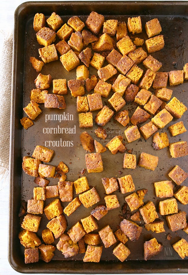 Pumpkin Cornbread Croutons on a sheet pan.