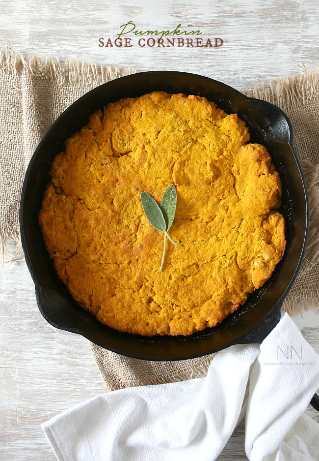 This simple homemade pumpkin sage cornbread can be eaten alone or turned into croutons and then into stuffing. Moist cornbread with a buttery crust - what's not to love? Pumpkin Cornbread with Sage in a cast iron dish.
