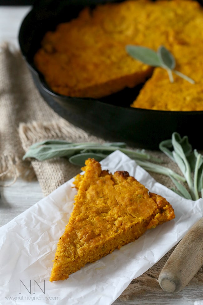 This simple homemade pumpkin sage cornbread can be eaten alone or turned into croutons and then into stuffing. Moist cornbread with a buttery crust - what's not to love? Pumpkin Cornbread with Sage sliced on a piece of parchment paper.