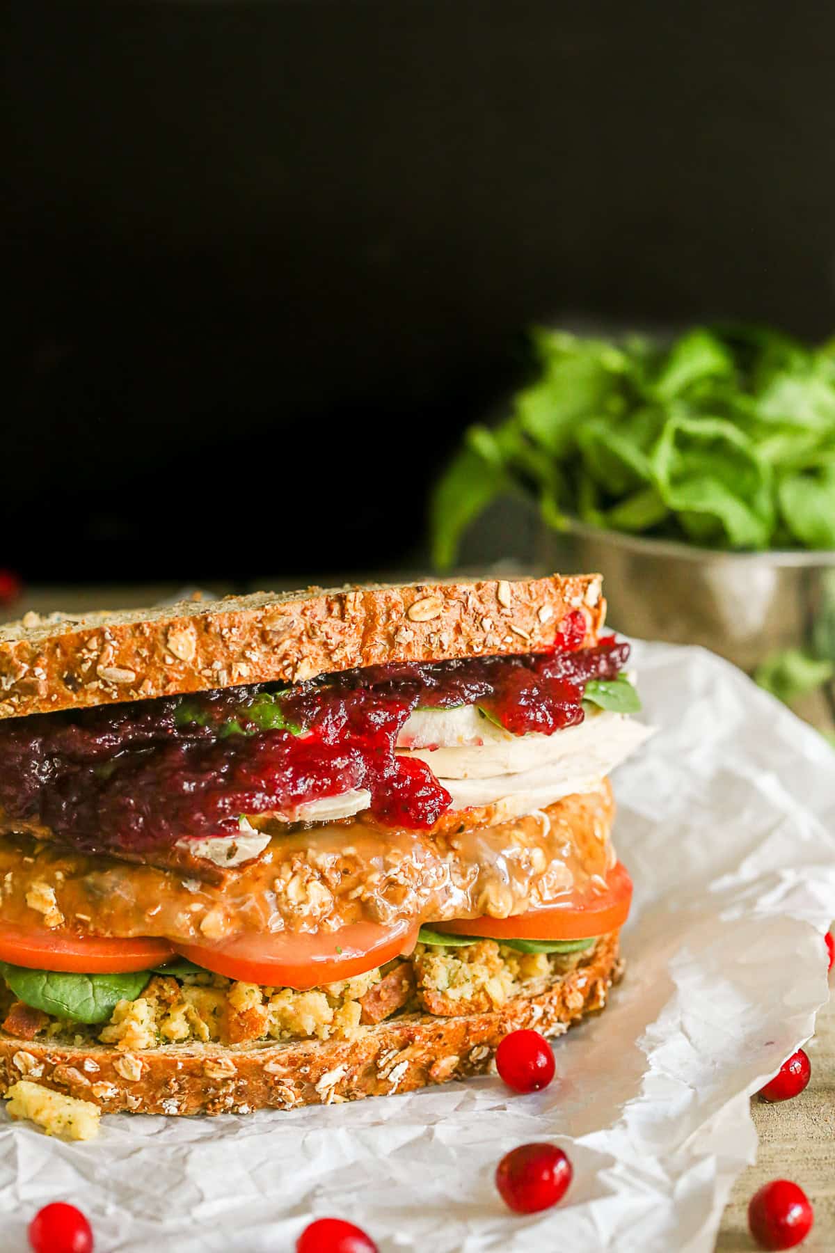 This leftover Thanksgiving sandwich with moist maker is the perfect way to pay homage to your favorite Friends episode. All the taste of a Thanksgiving dinner with a secrete gravy soaked moist maker middle! Leftover Thanksgiving Sandwich sitting on parchment paper.
