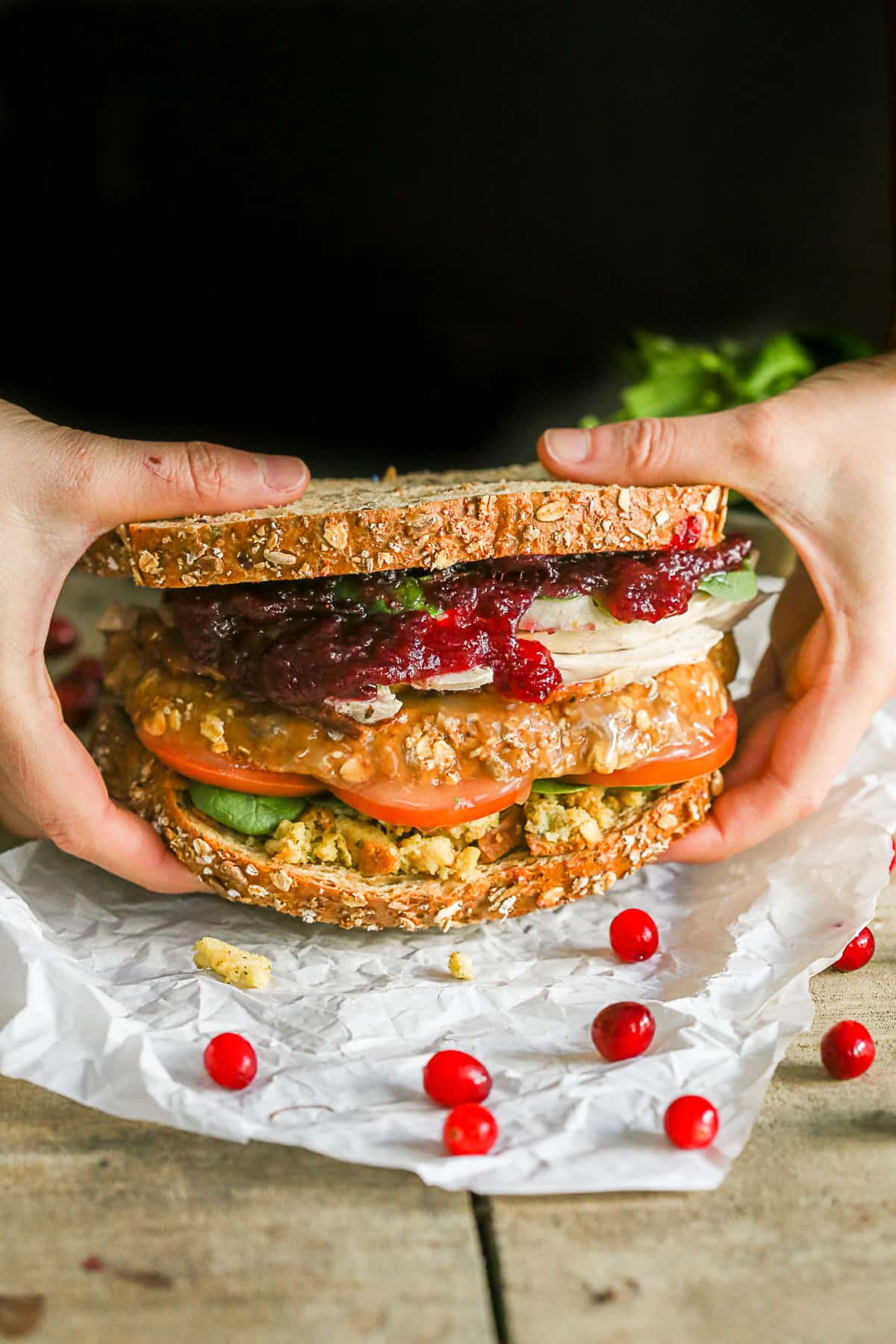 This leftover Thanksgiving sandwich with moist maker is the perfect way to pay homage to your favorite Friends episode. All the taste of a Thanksgiving dinner with a secrete gravy soaked moist maker middle! Two hands picking up a Leftover Thanksgiving Sandwich.