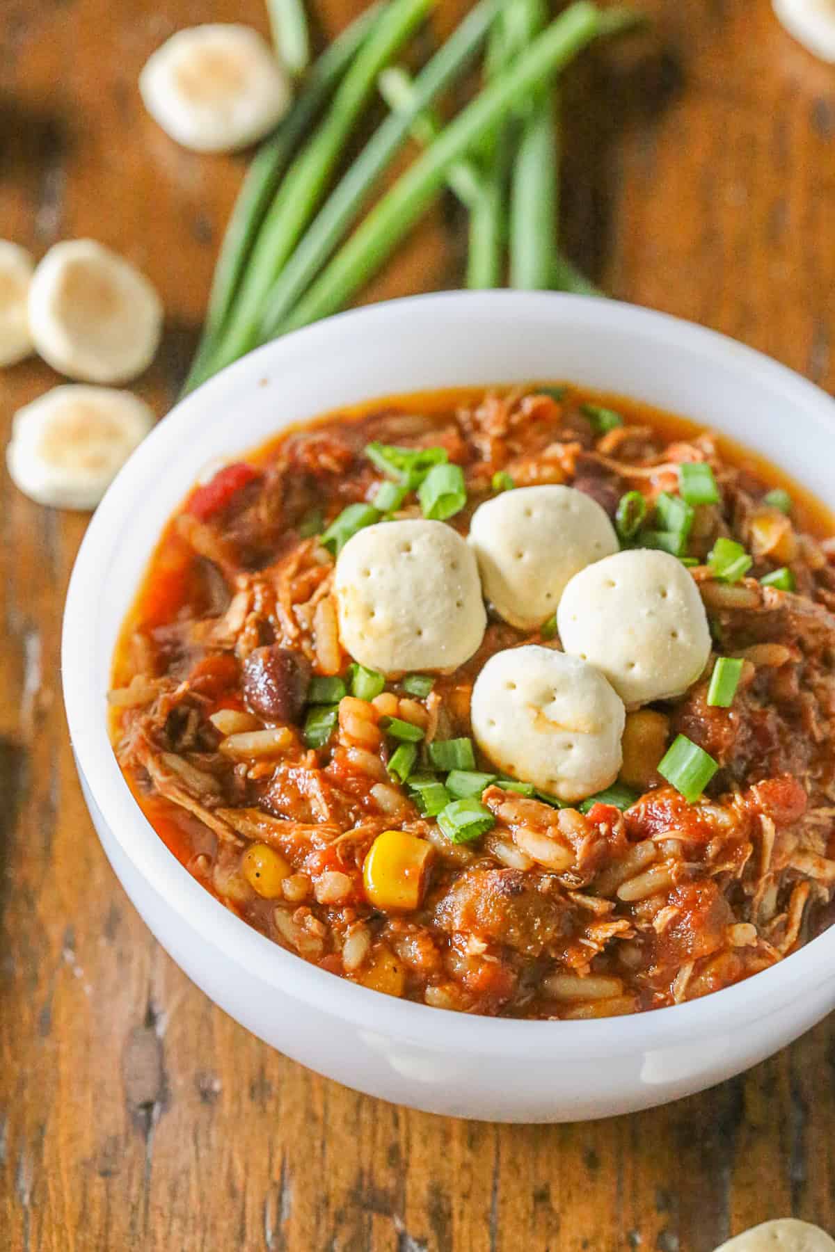 This simple turkey wild rice chili is the perfect way to use up all that leftover Thanksgiving turkey. Full of spicy flavor and perfect when topped with crackers. Turkey Wild Rice Chili in a bowl topped with crackers.