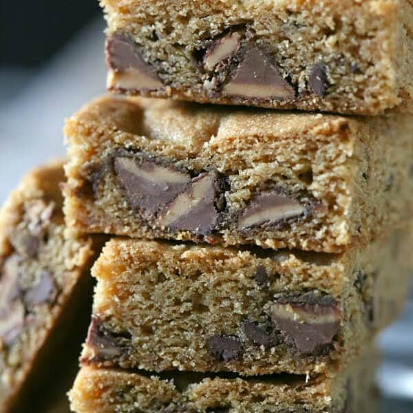 These peanut butter stuffed chocolate chip cookie bars are bursting with lots of peanut butter deliciousness. Serve warm with a big glass of cold milk.