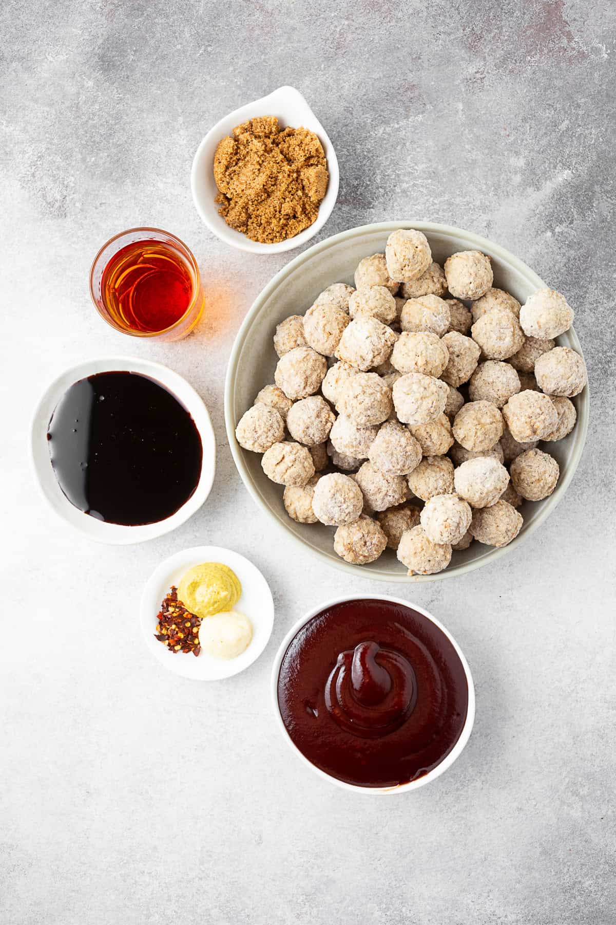 Ingredients to make Slow Cooker Bourbon BBQ Meatballs on a table. 