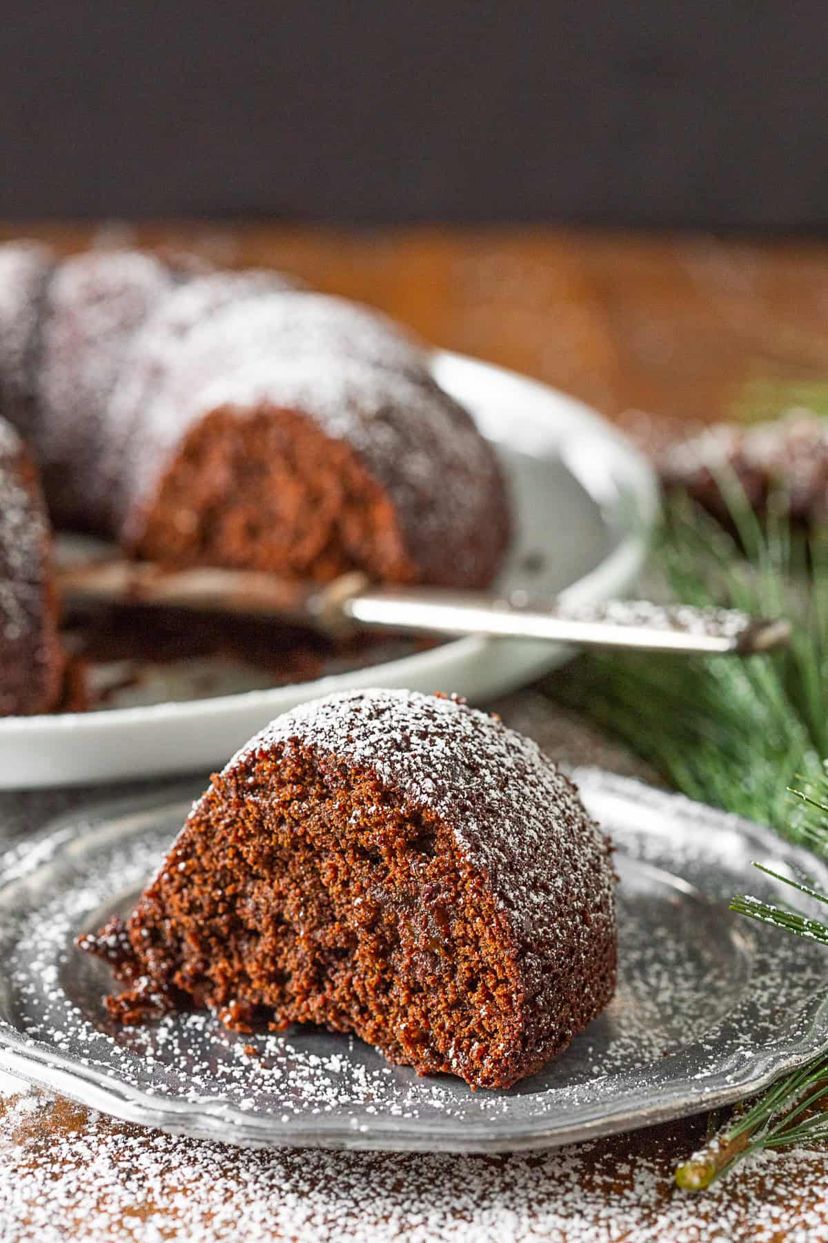 Chocolate Orange Gingerbread Cake sliced on a plate. 