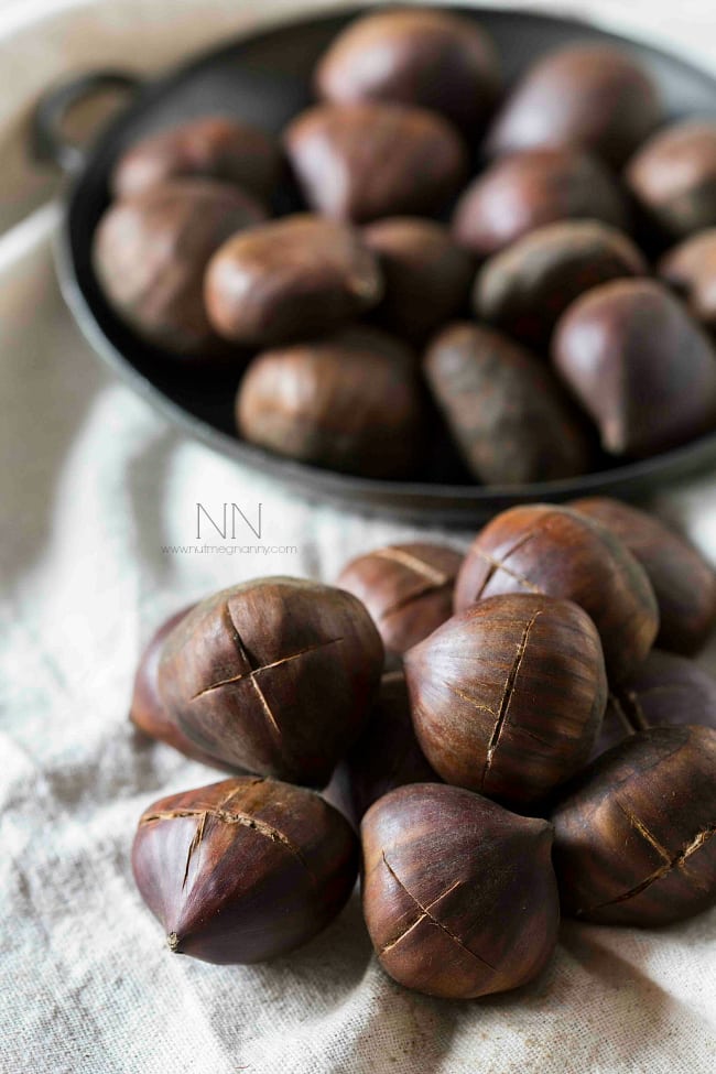 Fresh chestnuts with an X marked on their top. 