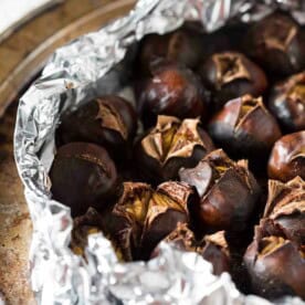 Roasting you own chestnuts isn't hard! Not only do I show you how but I give you a sweet recipe for spice butter roasted chestnuts as well. Hello Christmas!