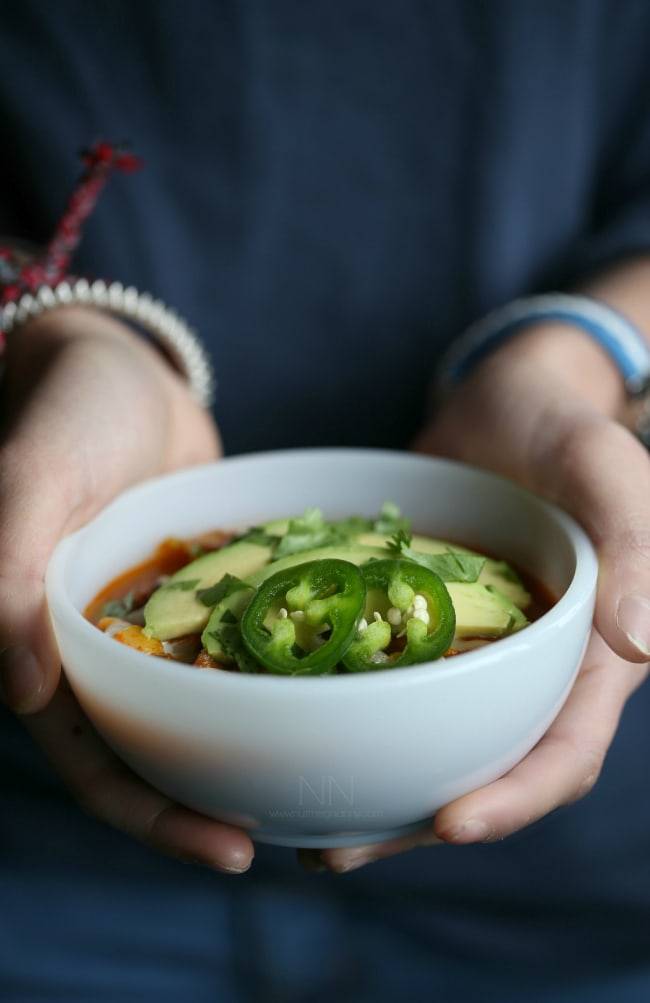A hand holding a bowl of Slow Cooker Beef Chorizo Taco Chili. 