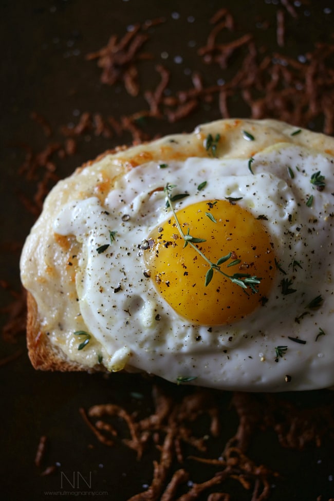 Croque Madame sprinkled with fresh herbs. 