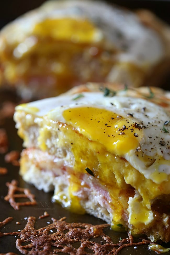 Croque Madame cut in half to show runny egg. 
