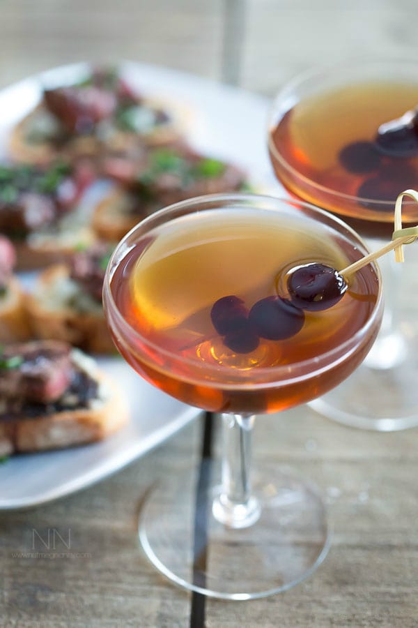 Manhattan Cocktail garnished with cherries. 