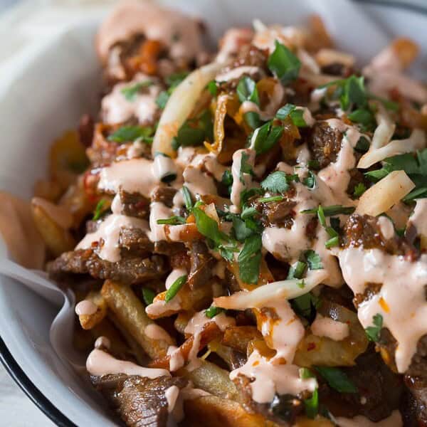 These totally loaded kimchi fries are the perfect flavor packed appetizer or main course. Crispy fries topped with melted cheese, seasoned beef and sautéed kimchi.