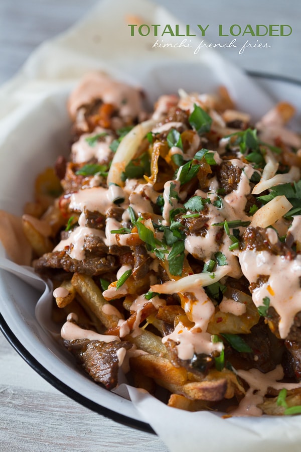 These totally loaded kimchi fries are the perfect flavor packed appetizer or main course. Crispy fries topped with melted cheese, seasoned beef and sautéed kimchi. So easy!