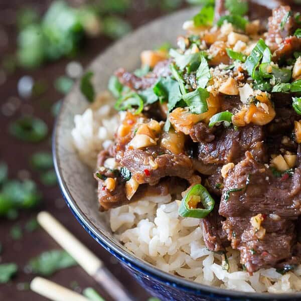 Say hello to your new favorite 20 minute meal. This spicy beef with peanuts is super easy and combines quick marinaded beef, peanuts and cilantro over top light brown basmati rice.