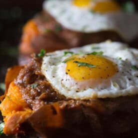 Dinner has never been so easy! These chipotle bbq pulled pork stuffed sweet potatoes combine homemade slow cooker chipotle pulled pork and stuff it inside a sweet potato and top with cilantro.