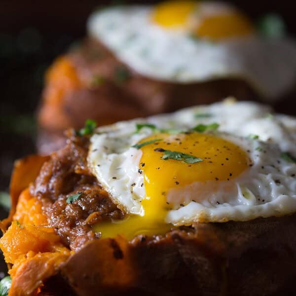 This chipotle bbq pulled pork stuffed sweet potato is packed full of flavor. Slow cooker chipotle pulled pork is stuffed into a soft baked potato and topped with a sprinkle of cilantro.