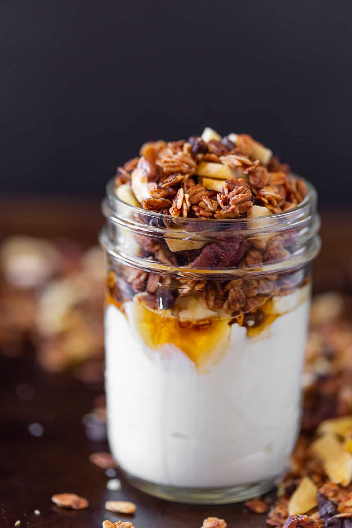 Banana Bread Granola served overtop yogurt with maple syrup.