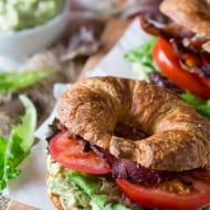 This avocado egg salad BLT is the perfect spring sandwich. Hard boiled eggs and creamy avocado pilled high on a croissant with crispy bacon, lettuce and tomato.