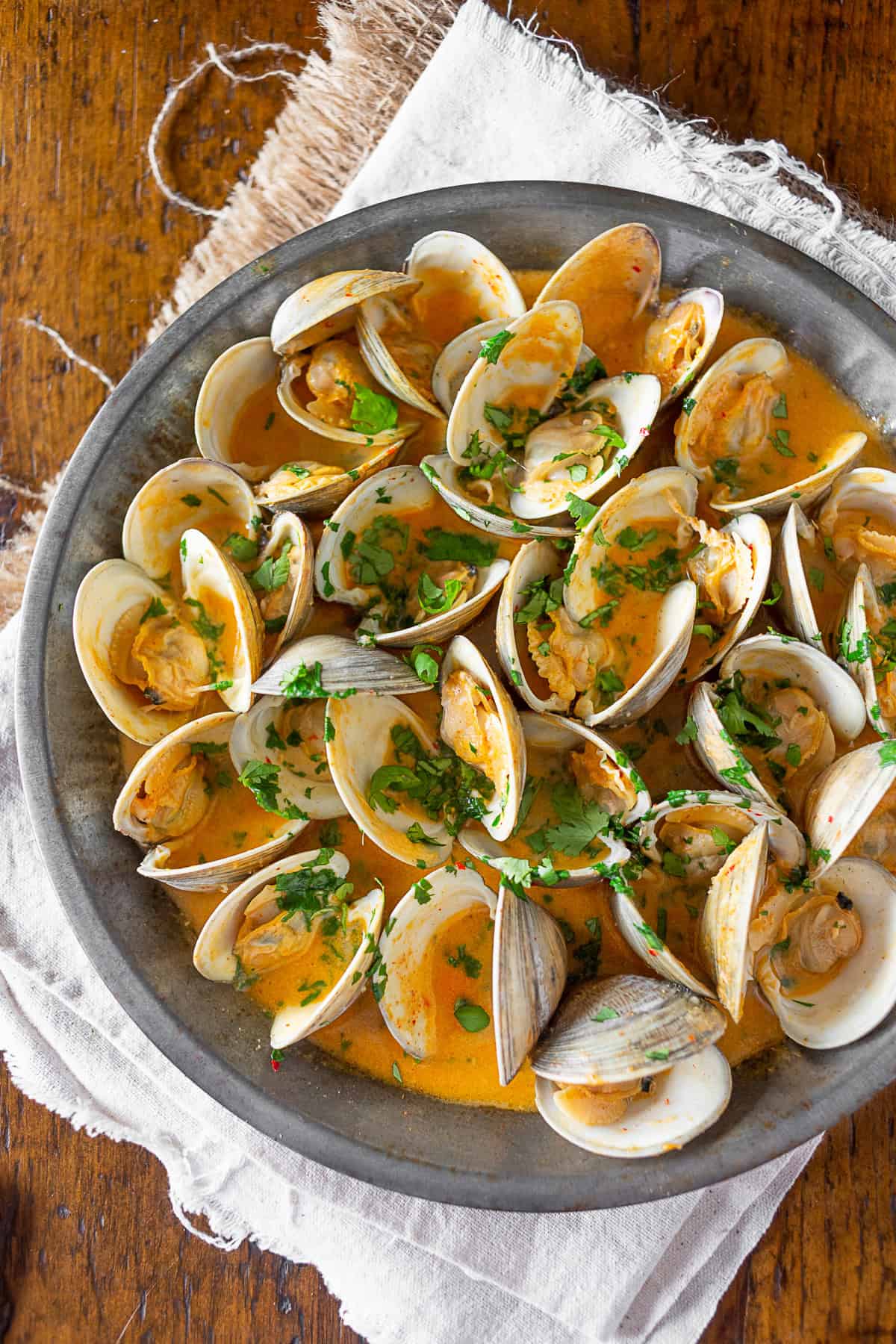 Spicy Coconut Milk Clams sprinkled with cilantro.