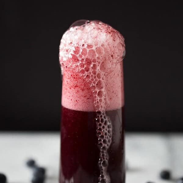 This mixed berry bellini is perfectly sweet and and packed full of blueberry and strawberry flavor. Served with a sugar rim and topped with sweet sparkling wine or prosecco.