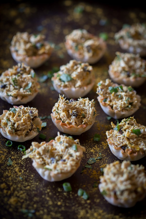 These little curried chicken salad phyllo cups are packed full of Greek yogurt, curry spice, cilantro and green onions. Then it's all packed into a crunchy phyllo cups for the perfect party appetizer. So simple and ready in under 30 minutes!
