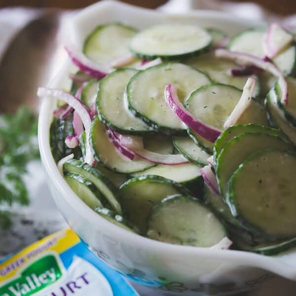greek yogurt ranch cucumber salad in a bowl with a small packet of ranch seasoning on the side