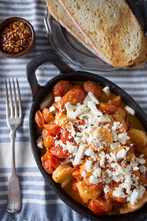 This skillet sherry shrimp and tomatoes is ready in under 30 minutes and packed full of spicy shrimp, feta cheese and cherry tomatoes. So easy and fresh! Serve over rice or couscous!