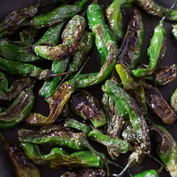 These blistered shishito peppers are the perfect summertime vegetable snack. Cooked quickly in oil and sprinkled with kosher salt for veggie perfection.