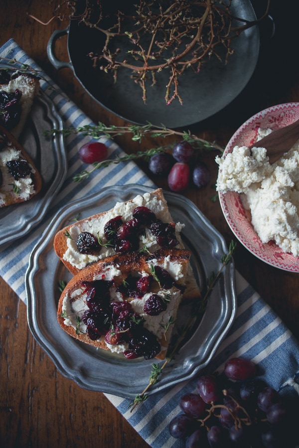 This roasted grape crostini is flavored with fresh thyme and piled high on top of ricotta toast. Super easy to make and ready in under 30 minutes!