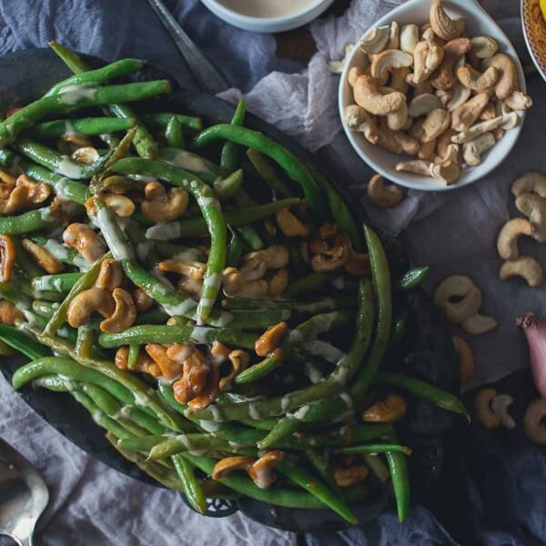 These Girl and the Goat Magic Beans taste just like beans you can get in the Chicago restaurant. Perfectly crisp, flavorful and ready in no time. Flavored with fish sauce vinaigrette and sautéed with crunchy cashews.