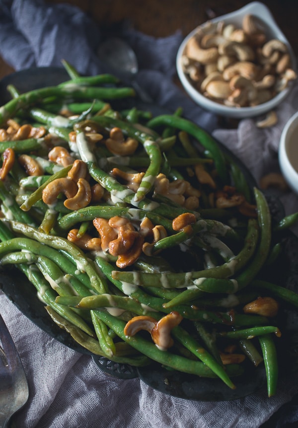 Girl and the Goat Magic Beans topped with nuts and aioli.