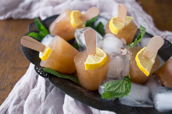 These sweet tea popsicles are the perfect way to enjoy summer. I froze up Southern sweet tea flavored with lemon and mint to create the perfect hot summer day treat.