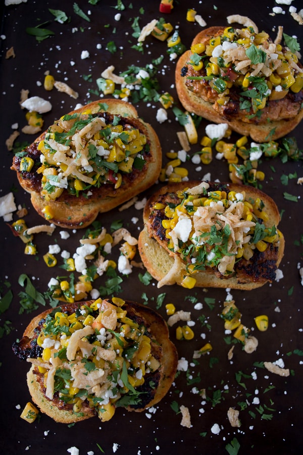 bbq chicken burgers topped with peach salsa and crispy onions. 