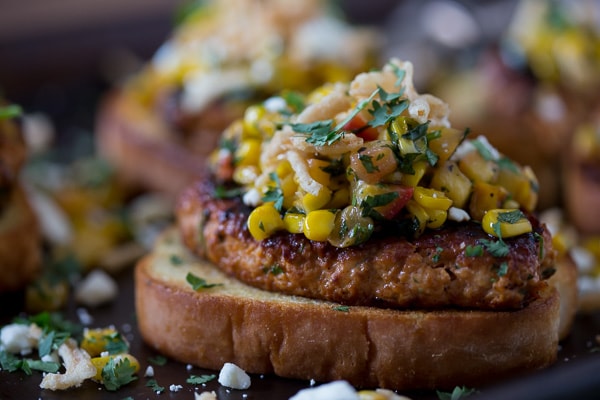 bbq chicken burger topped with salsa. 