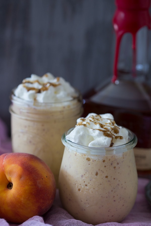 This vanilla peach bourbon milkshake is the perfect boozy summertime frozen treat. Vanilla bean paste mixed with fresh peaches, bourbon and vanilla bean ice cream. It's the perfect cocktail + dessert!