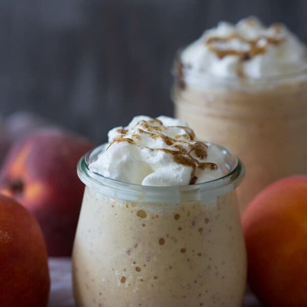 This vanilla peach bourbon milkshake is the perfect boozy summertime frozen treat. Vanilla bean paste mixed with fresh peaches, bourbon and vanilla bean ice cream. It's the perfect cocktail + dessert!