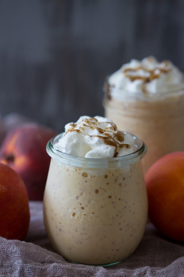 This vanilla peach bourbon milkshake is the perfect boozy summertime frozen treat. Vanilla bean paste mixed with fresh peaches, bourbon and vanilla bean ice cream. It's the perfect cocktail + dessert!