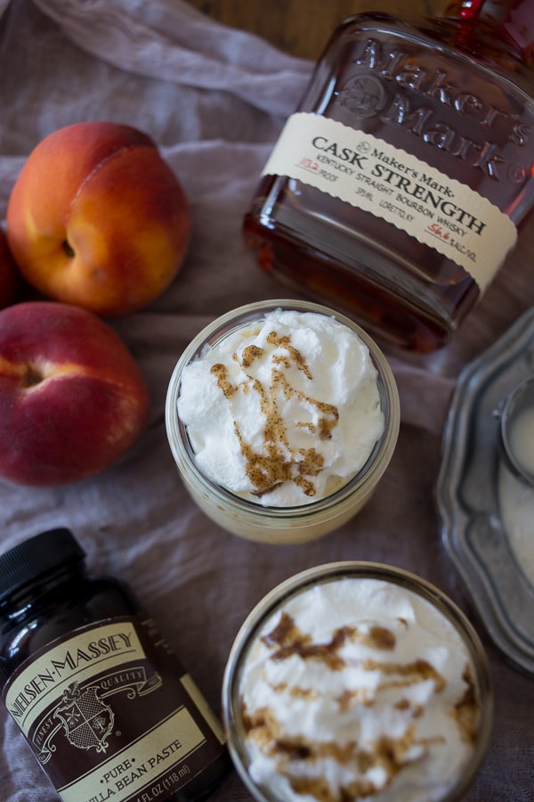 This vanilla peach bourbon milkshake is the perfect boozy summertime frozen treat. Vanilla bean paste mixed with fresh peaches, bourbon and vanilla bean ice cream. It's the perfect cocktail + dessert!