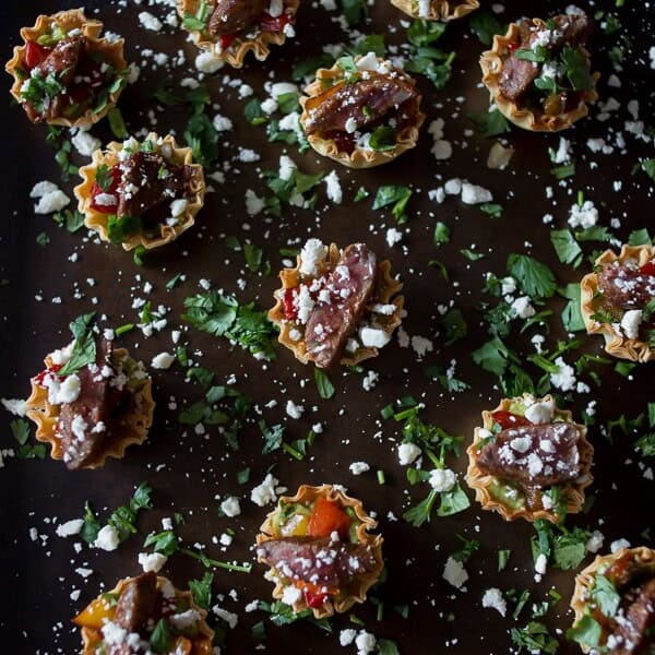These mini steak fajita phyllo bites are the perfection combination of guacamole, peppers, steak, cheese and cilantro all in one mini phyllo cup bite.