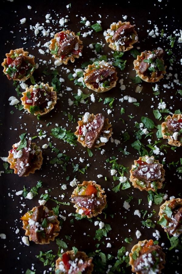 These mini steak fajita phyllo bites are the perfection combination of guacamole, peppers, steak, cheese and cilantro all in one mini phyllo cup bite.