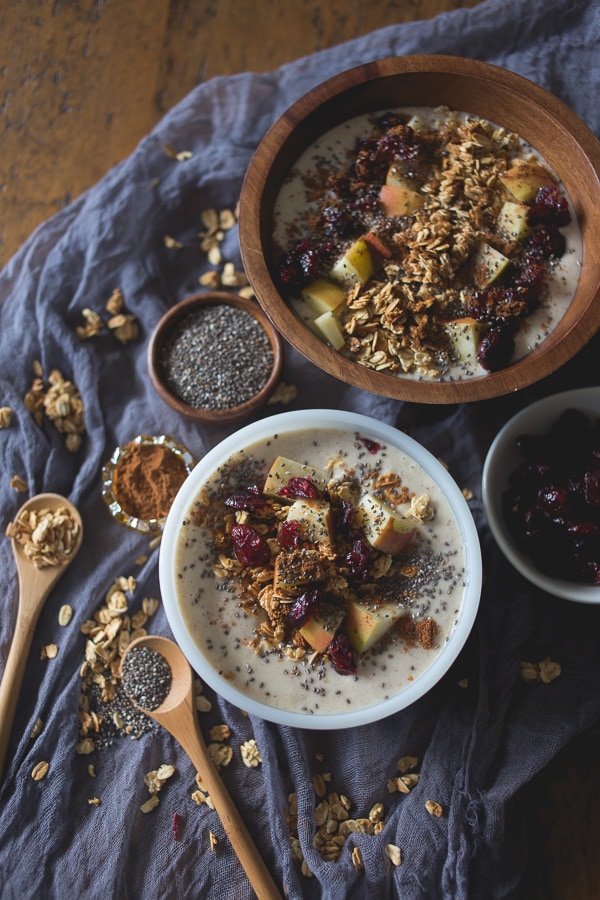 Apple Pie Smoothie Bowl served in 2 bowls topped with apples, and apple pie seasoning.